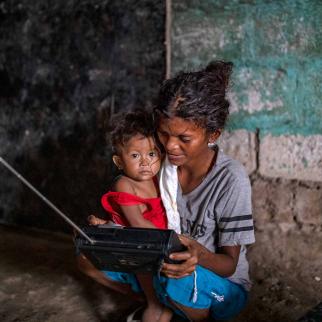 A woman holds her child in the remote village of Burog, in Bamban, Tarlac province, Philippines.