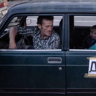 A family from Mariupol wait in their car to be registered by police after arriving at an evacuation point for people fleeing Mariupol, Melitopol and the surrounding towns under Russian control on May 02, 2022 in Zaporizhzhia, Ukraine.