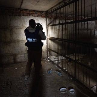 A Ukrainian cameraman filming a metal cage built by Russian troops for detentions. The Ukrainian prosecutor’s office is investigating several criminal cases related to the abduction of local reporters in Melitopol, an occupied city in the Zaporizhzhia region.