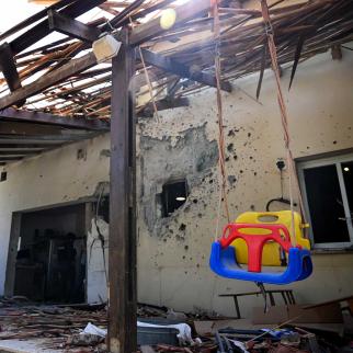 A swing is left intact while most the house is left in ruins, where five family members were kidnapped and three are still missing, after Hamas militants attacked this kibbutz near the Gaza border.