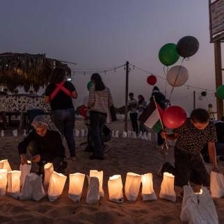 A Lebanese girl lights a candle during an event honouring Issam Abdallah, Lebanese photojournalist killed by a missile strike of the IDF on October 13 while working in southern Lebanon, on October 22, 2023 in Beirut, Lebanon. Journalists and other civilians have been killed or wounded as Lebanon's southern frontier with Israel sees its most active fighting in years, with the Lebanon-based Hezbollah militant group trading cross-border fire with Israel over the last two weeks. Regional tensions have flared fo