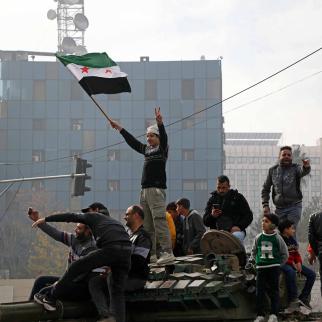 People react to the fall of Syrian regime in Umayyad Square on December 8, 2024 in Damascus, Syria. Rebel forces in Syria claimed that they had retaken the capital from longtime ruler Bashar al-Assad, who was reported to have fled the country.