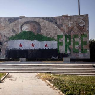 A defaced mural of Hafez al-Assad, father of former Syrian President Bashar al-Assad is seen on a highway on the outskirts of Damascus on December 17, 2024.
