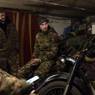 Service members of Ukraine's 13th Brigade Khartiia wait for the target's coordinates in a former house's garage to operate an American-supplied M101 howitzer on Russian combat positions on March 06, 2025, in the Kharkiv region of Ukraine.