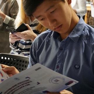 A member of audience going through the report.