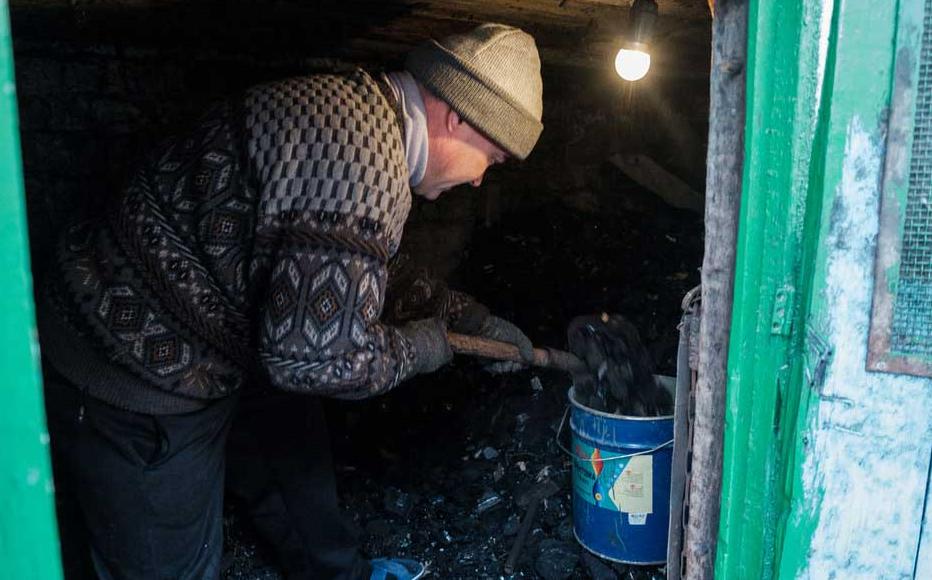 Oleg, a resident of the Novopokrovka village, in the suburbs of Bishkek, in his house’s coal storage. Many people fill stoves with coal to heat their houses. Oleg, a resident of the Novopokrovka village, in the suburbs of Bishkek, in his house’s coal storage. Many people fill stoves with coal to heat their houses.