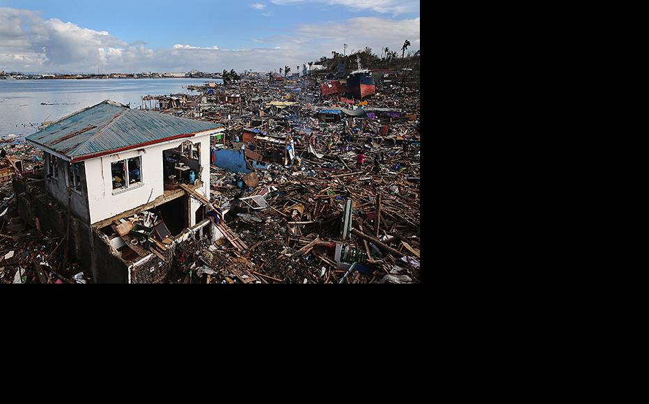 A man sits outside his home, the only one left standing in a particularly badly damaged area of Tacloban. (Photo: Dan Kitwood/copyright Getty Images)