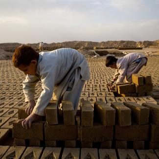 Roman , 7, sorts bricks at the Sadat Ltd. Brick factory where he works from 8am to 5pm daily, Kabul, Afghanistan.