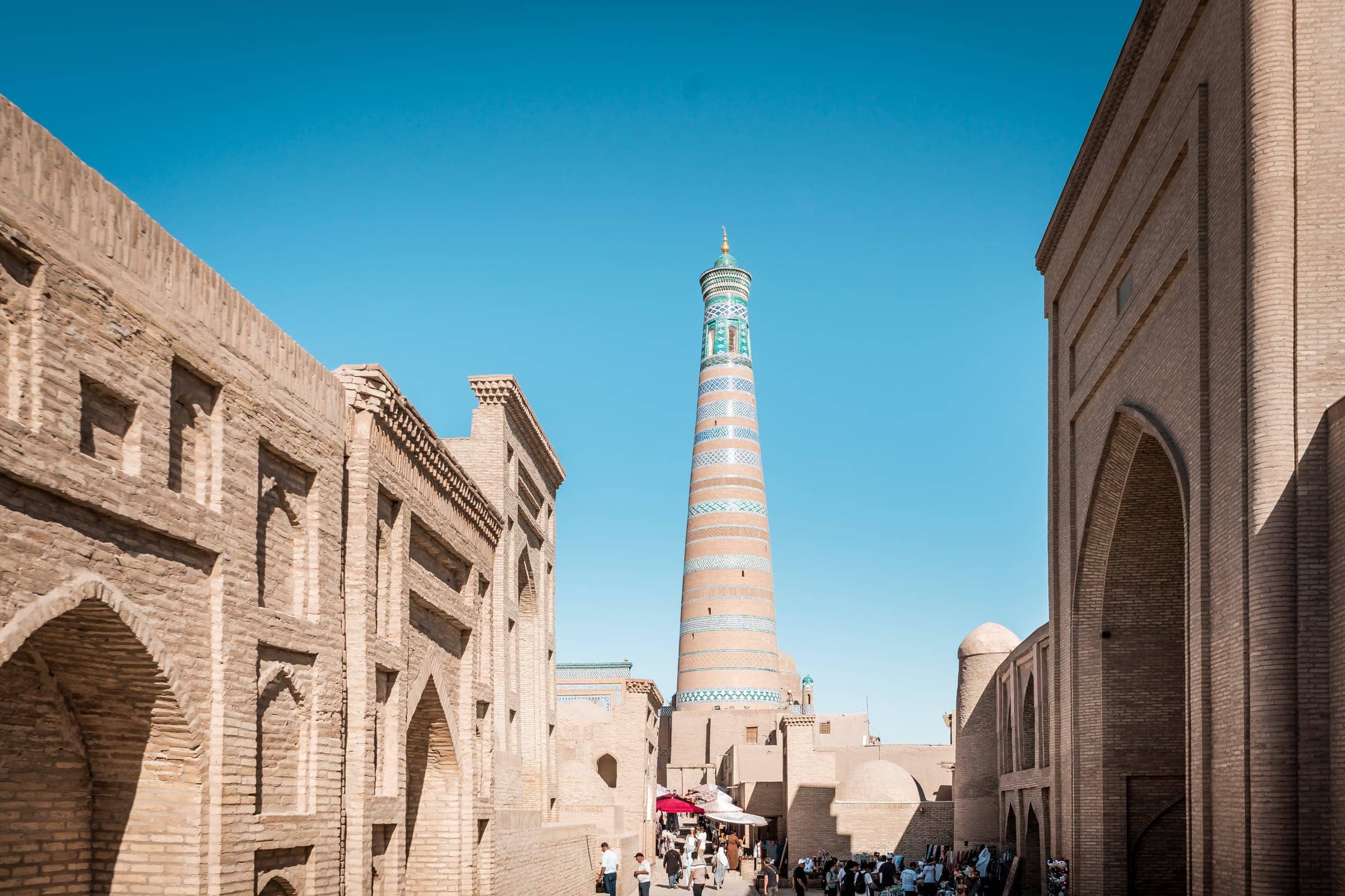 schlankes Minarett zwischen sandfarbenen Gebäuden