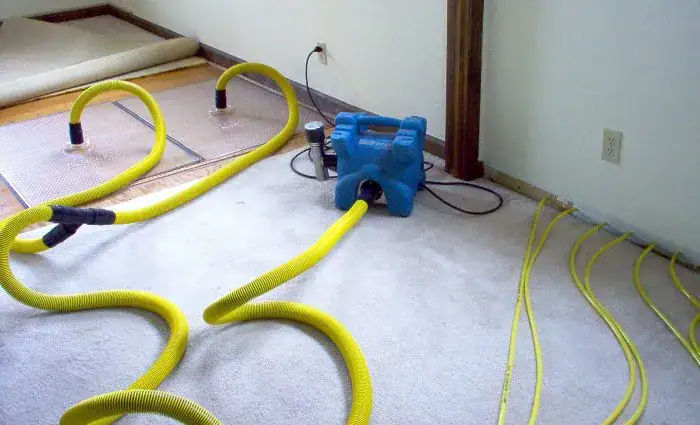 high power industrial water extraction tool on a flooded floor during water mitigation