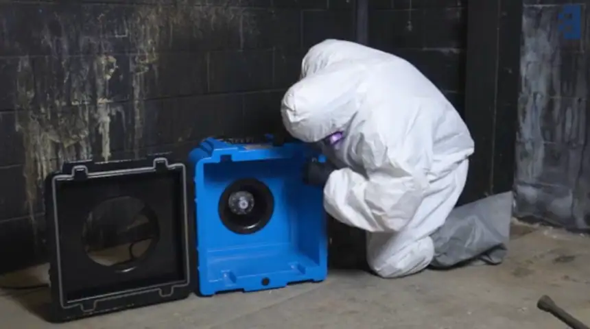industrial HEPA air scrubber machine running in a residential mold remediation containment zone