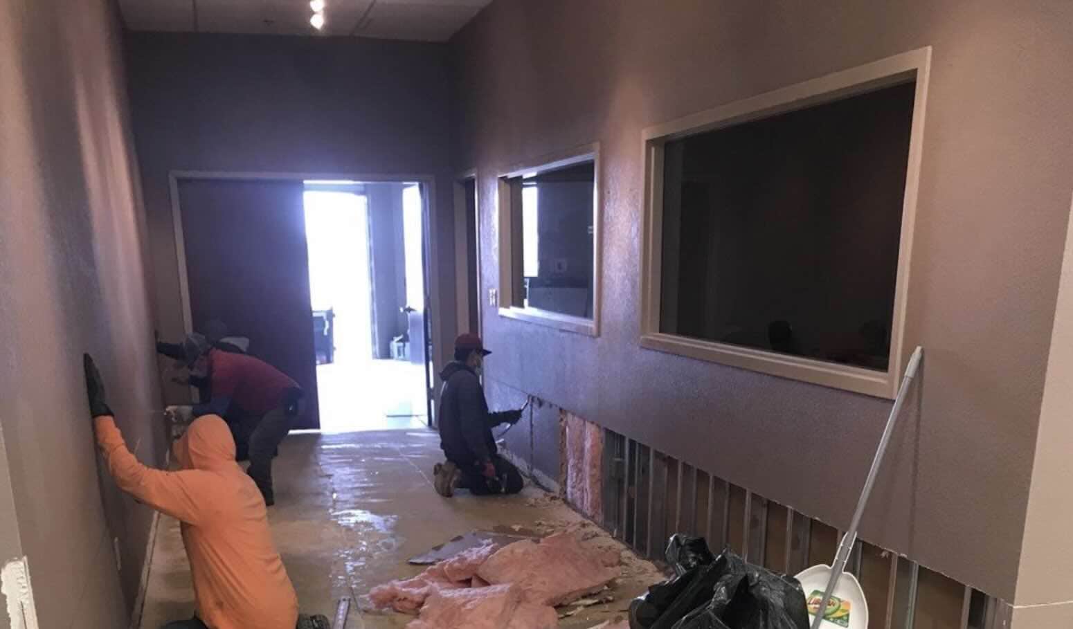 Rainy Day crew removing water-damaged materials inside a commercial property