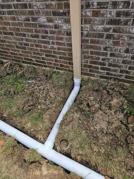 Yard drainage directing water away from a home's foundation in North Texas