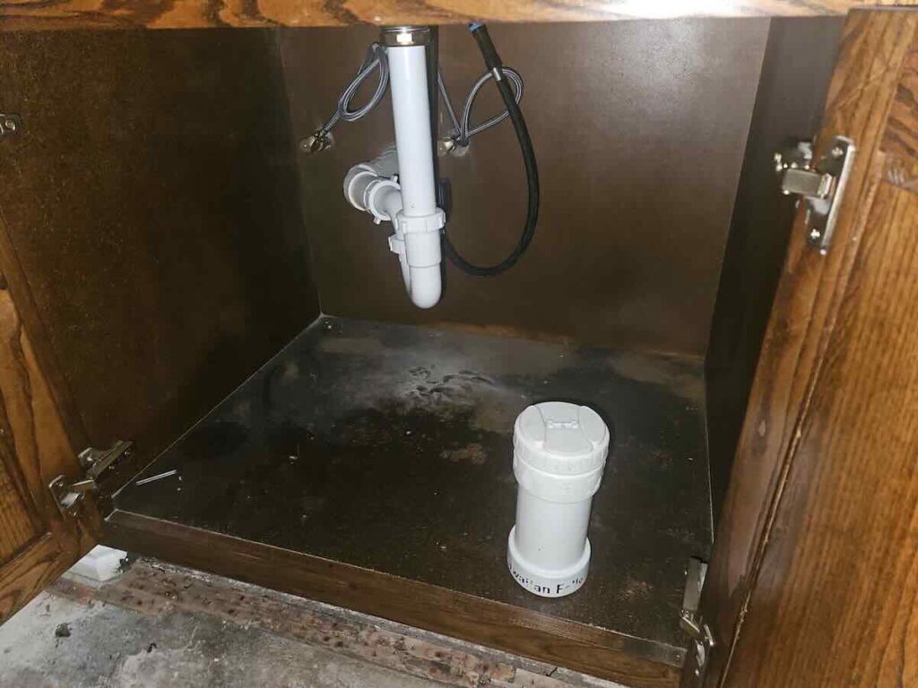 Water damage under a kitchen sink in Murphy, TX