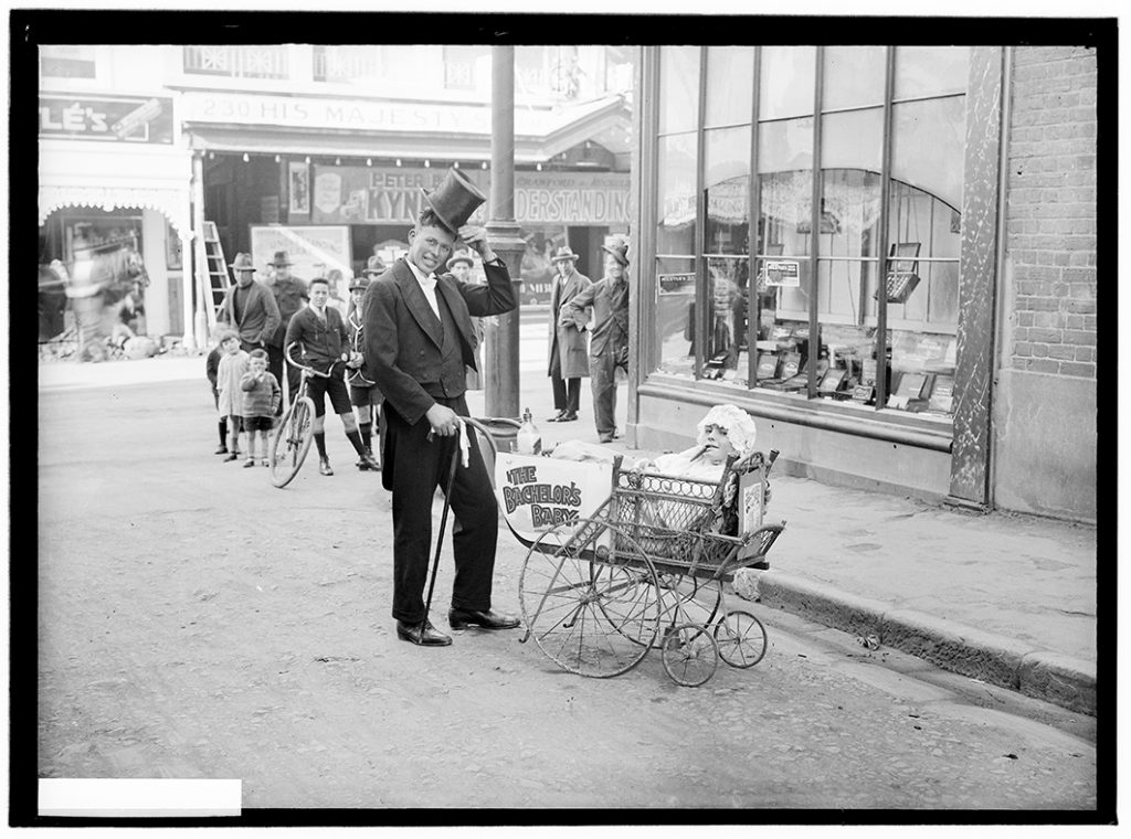 Photograph - Man with 'baby' in a pram to advertise the movie 'The Bachelor's baby' aug 1927 [glass plate negative] [His Majesty's Theatre, Liverpool Street]