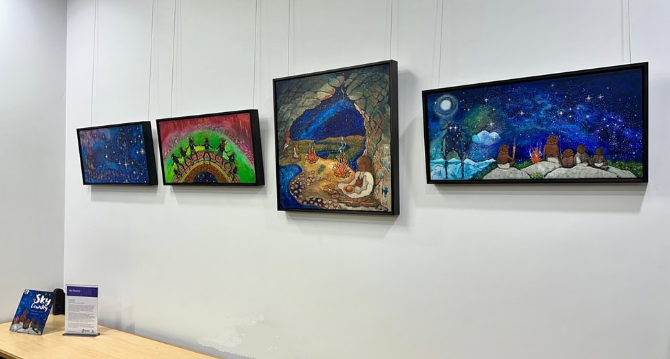 Four paintings hanging on a wall by Tasmanian Aboriginal artist Lisa Kennedy