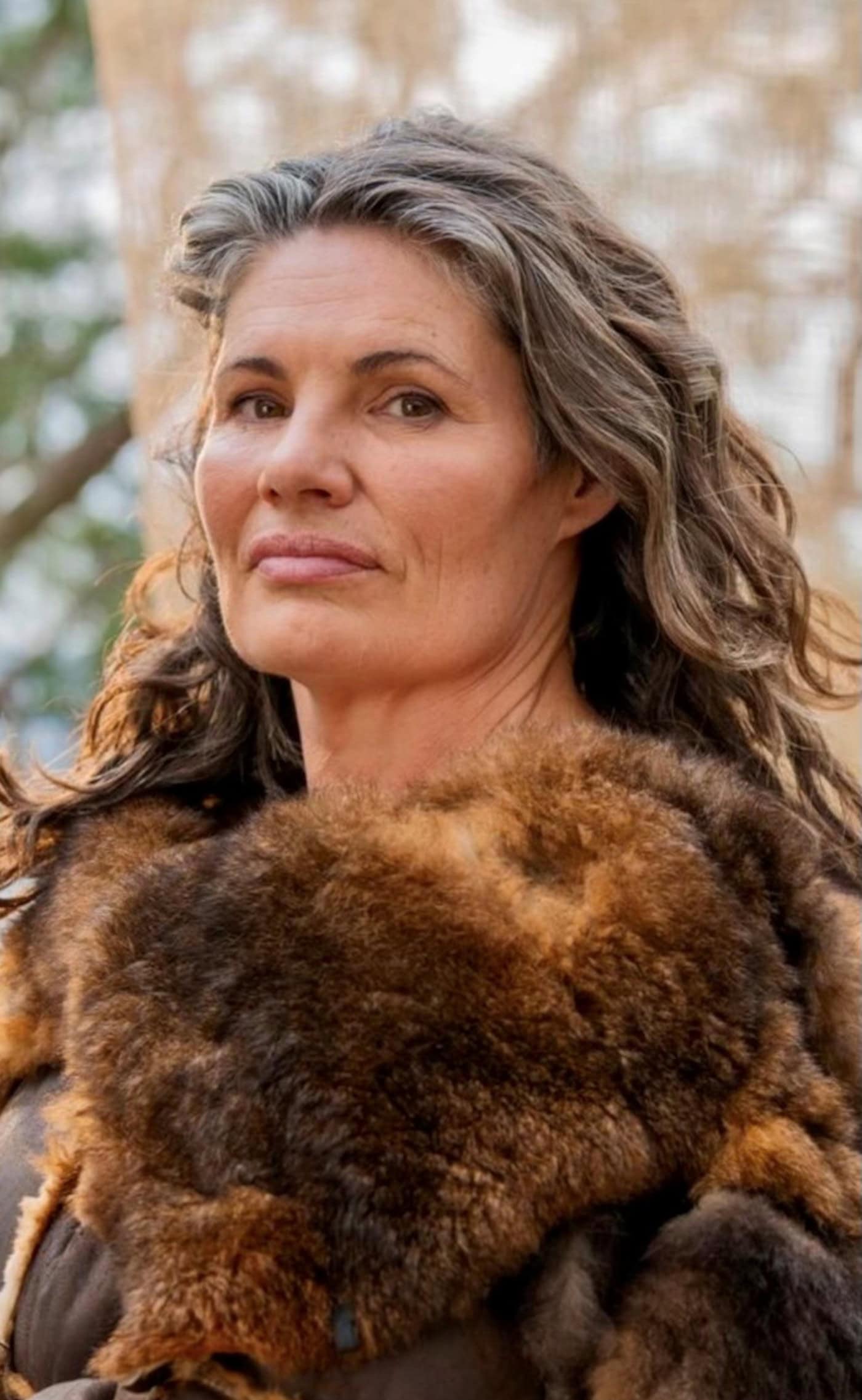 A woman with long hair wearing a fur coat