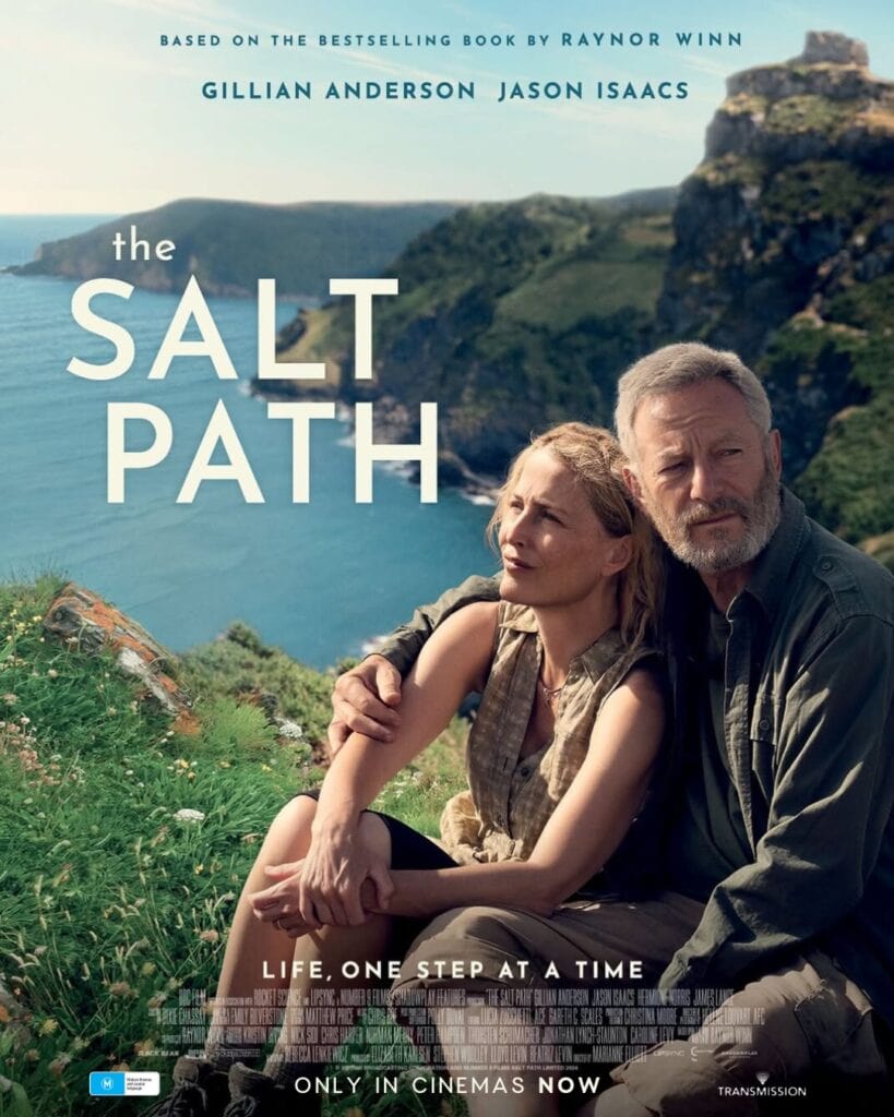 Movie poster for the Salt Path showing a man and a woman sitting near a lush cliff face. Copyright Transmission Films.