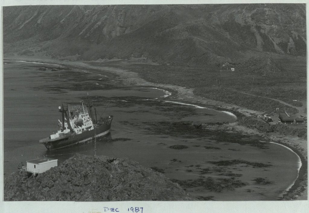 A metal ship. Grounded. as seen from above. Text at the bottom of the page reads: "Dec 1987"