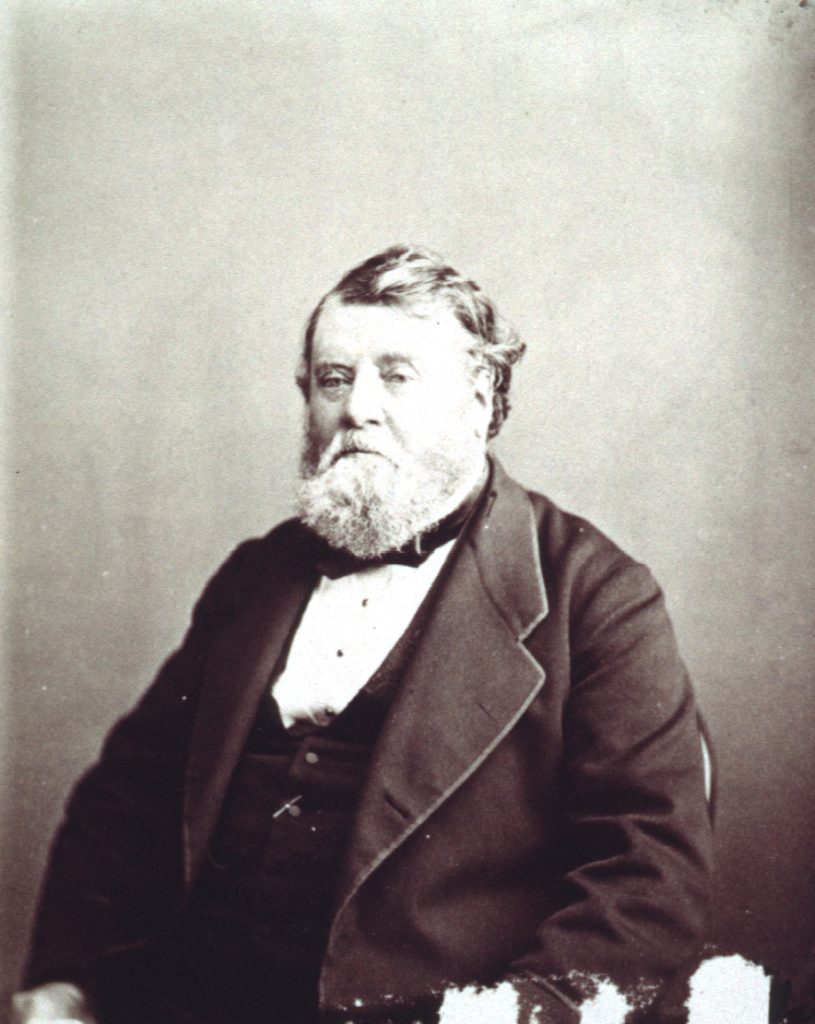 A black and white photo of a man sitting.