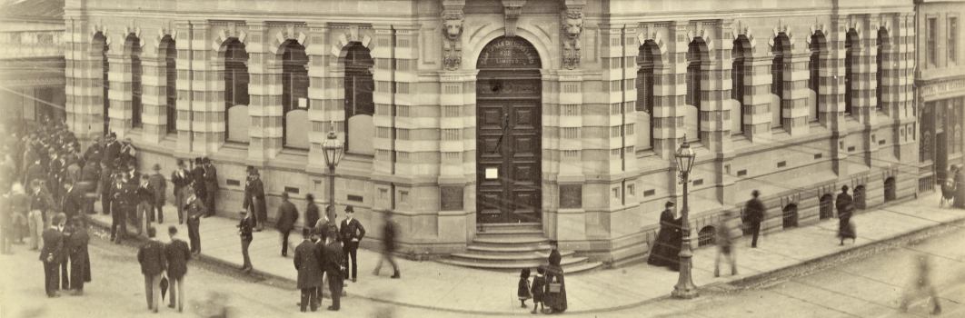 A picture of a brick building on a street corner.