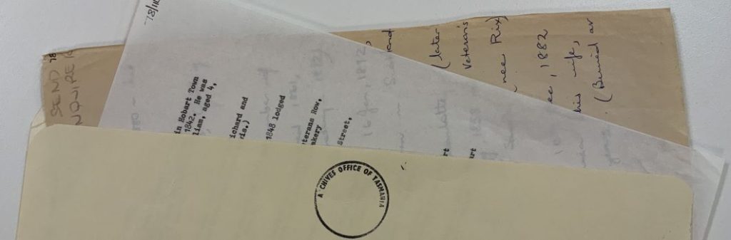 A picture of some files inside a manilla folder There is a circular stamp on the front which reads: "Archives office of Tasmania"