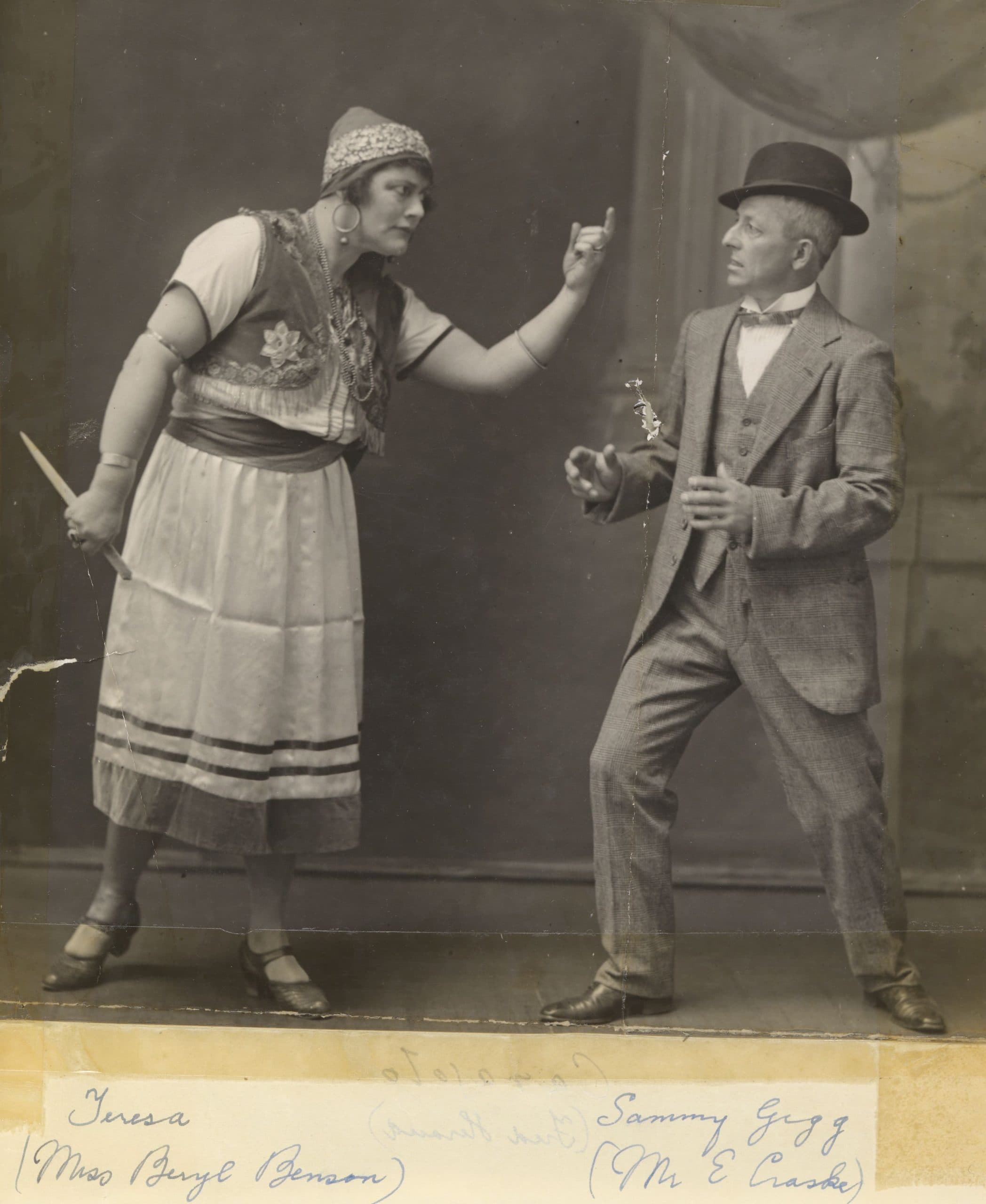 an old black and white photo of a woman pointing her finger at a man in a suit. the man looks worried.