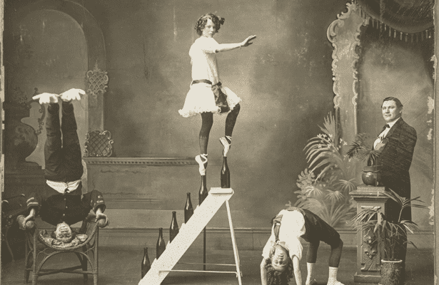 An image of a Balette dancer standing on her tip toes on bottles on stairs.