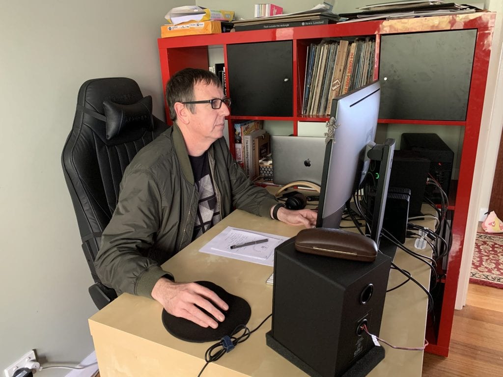 A picture of a man using a computer.