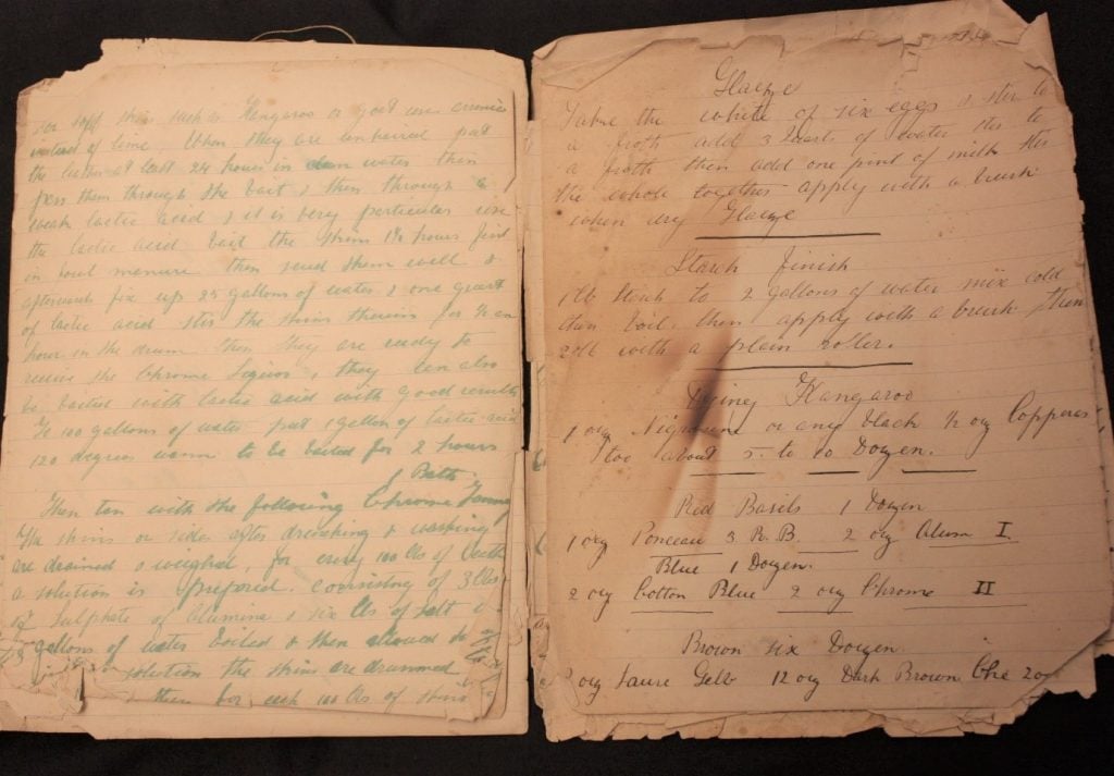 An open book with cursive writing on it.