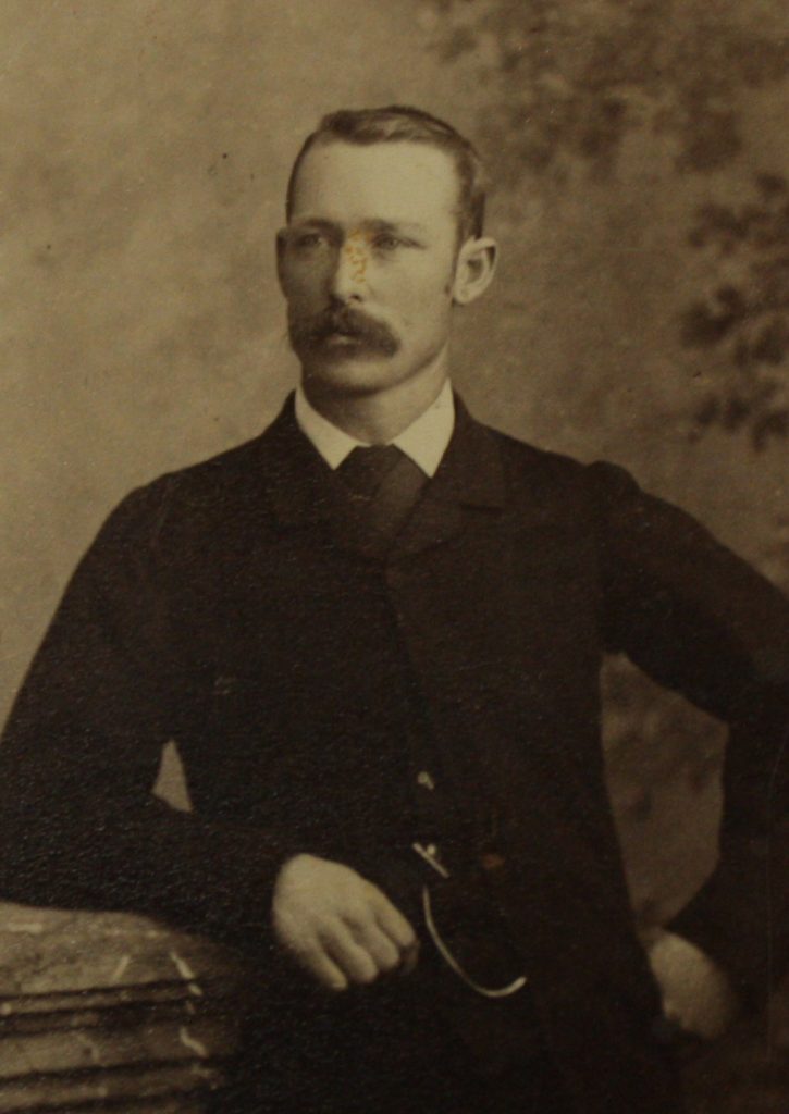 A black and white photo of a man having his picture taken.