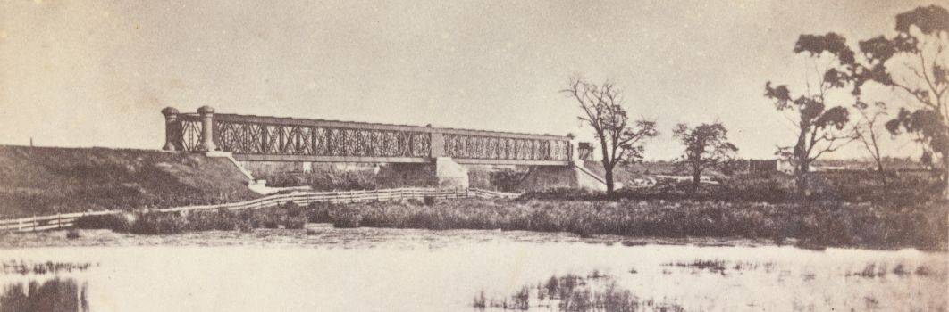 A black and white photo of a bridge.