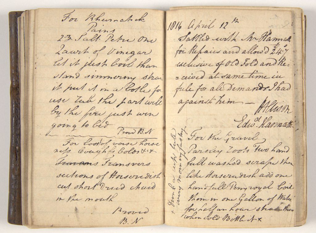 An open book with handwritten text. Text illegible