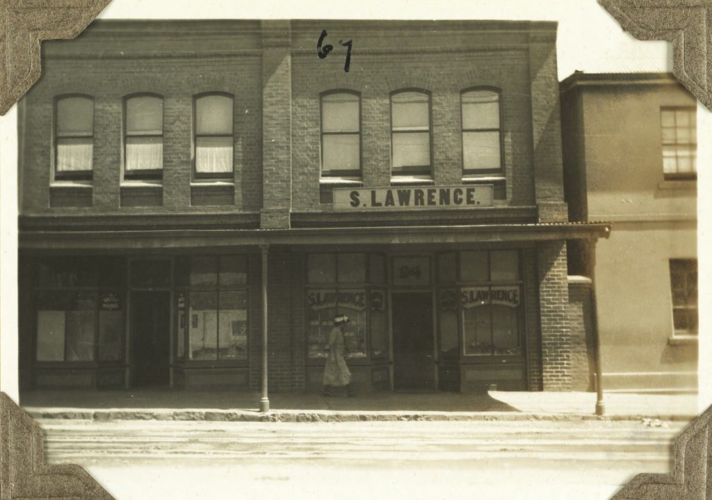A shop front as seen from the other side of the street. Text on the shop sign reads: "S. Lawrence"