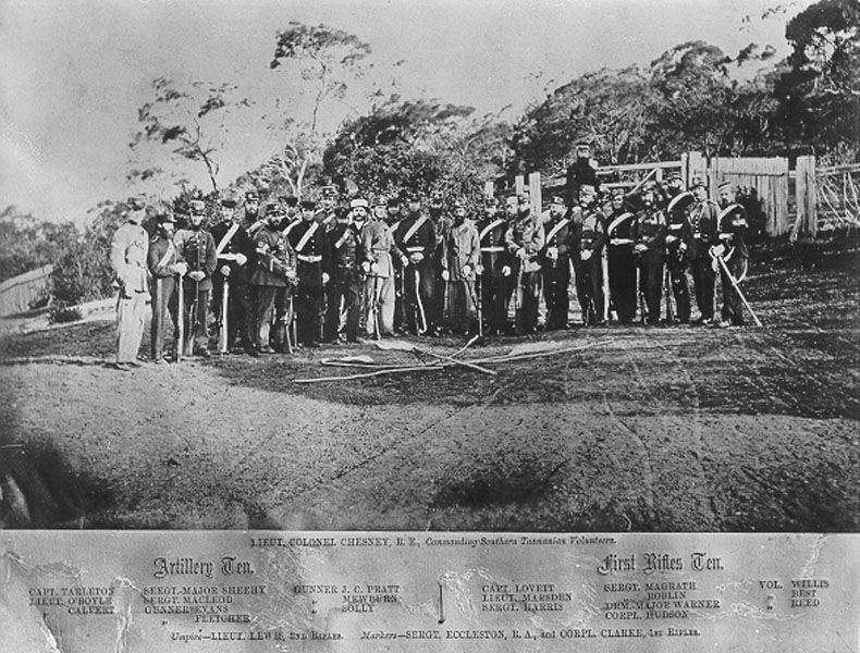 Men in officers uniform standing in a field. Text at the bottom of the image lists the men in the photo. Text is illegible