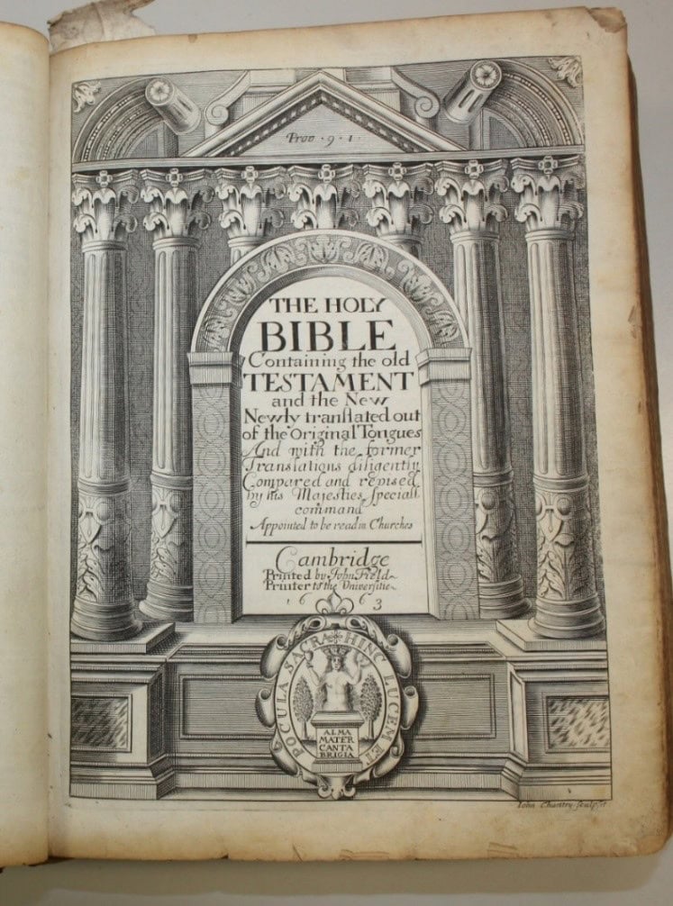The front page of a bible. The page has a pictures of columns with a plaque in the middle. the plaque reads: " The holy bible. Containing the old testament and the new. Newly translated out of the original tongues and with the former translations diligently compared and revised by his majesties special command. Appointed to be read in churches. Cambridge printed by john field printer to the Univerfitie