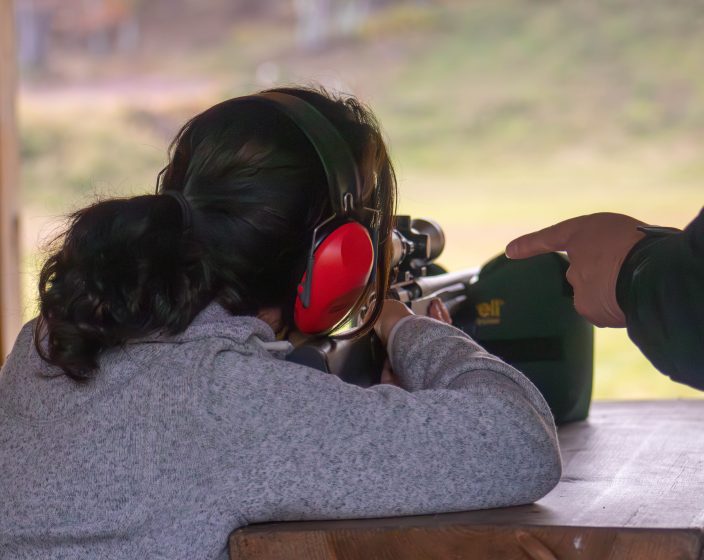 A women shooting a rifle