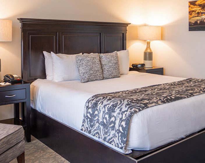 A made bed and a chair in a guest room at Skytop