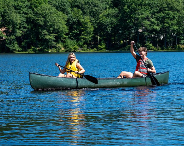 A young women and man in a canoe on the water