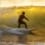 Surfing in Sligo with sun shining through waves