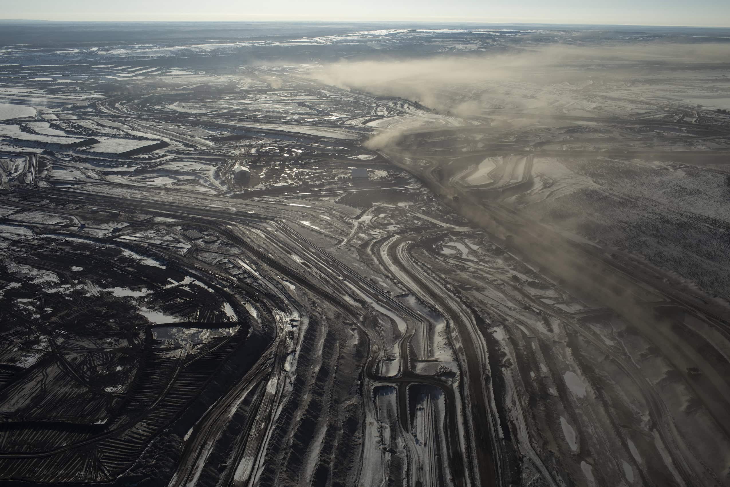 Aerial view over a sprawling patch of oilsands development