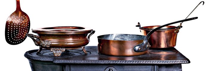 Copper Cookware on a shelf with the tin lining visible on one of the pans