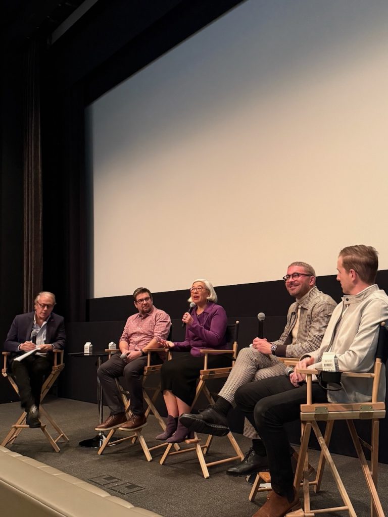 Five panelists seated on stage during post-screening Q&A for The American Question, Beverly Hills