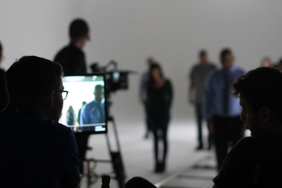 Crew members review footage on monitors during We the Future ad production in Los Angeles studio