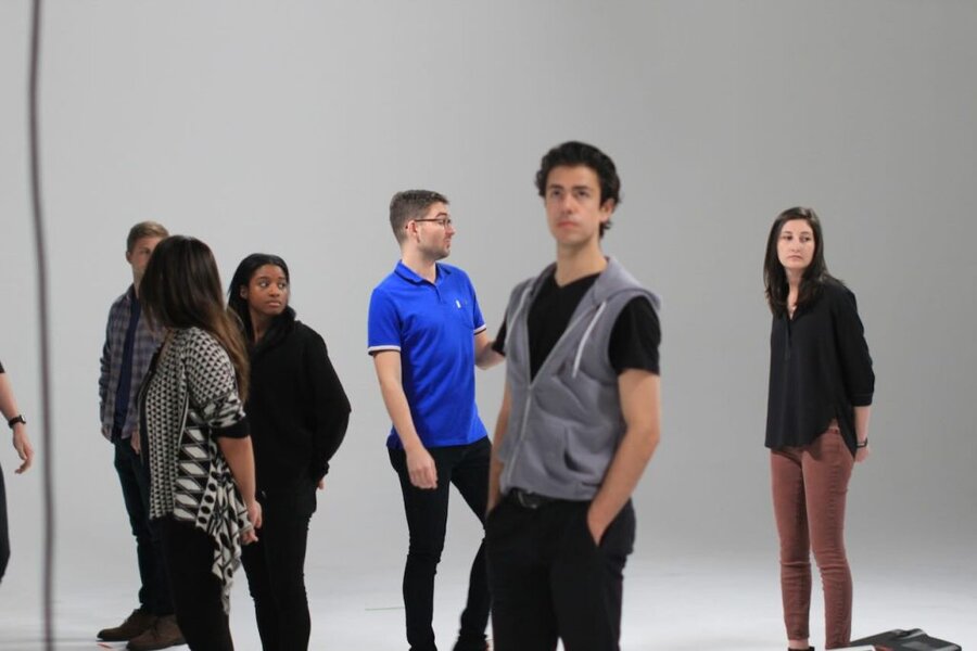 Production crew and talent on white cyclorama studio set during We the Future ad shoot in Los Angeles