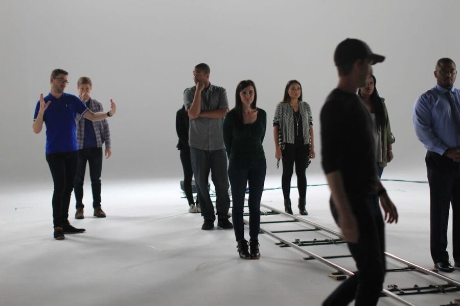 Director and talent gather in white studio during We the Future commercial production in Los Angeles