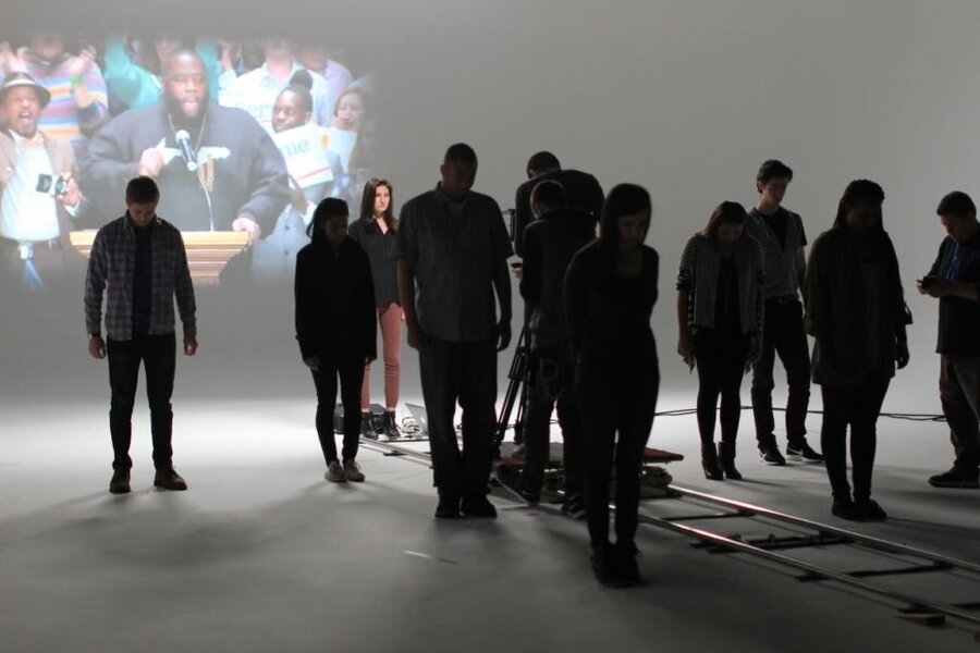 Silhouetted crew and talent viewing projection during We the Future commercial shoot in Los Angeles studio