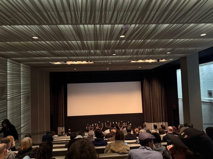 Audience at UTA industry screening for The American Question, Beverly Hills theater with stage and screen visible