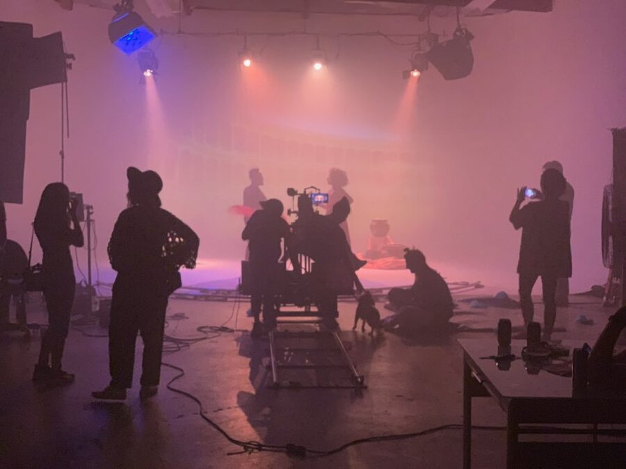 Film crew with cameras and lighting equipment on foggy stage set during Tulsa Opera ad campaign shoot by James Kicklighter