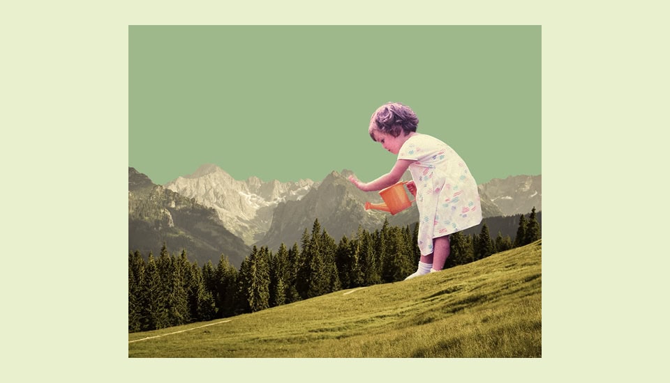 A young child in a dress waters a grassy hill with an orange watering can. Background features a forest and distant mountains under a pale green sky. The scene blends nature and imagination.